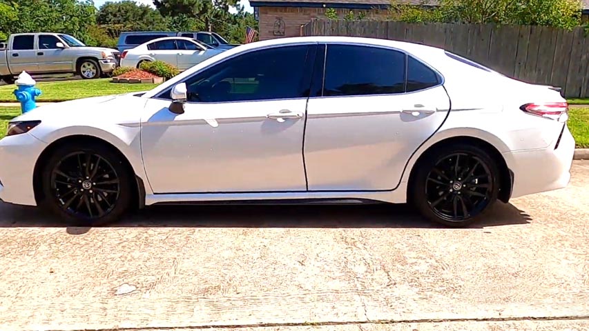 black rims on white car