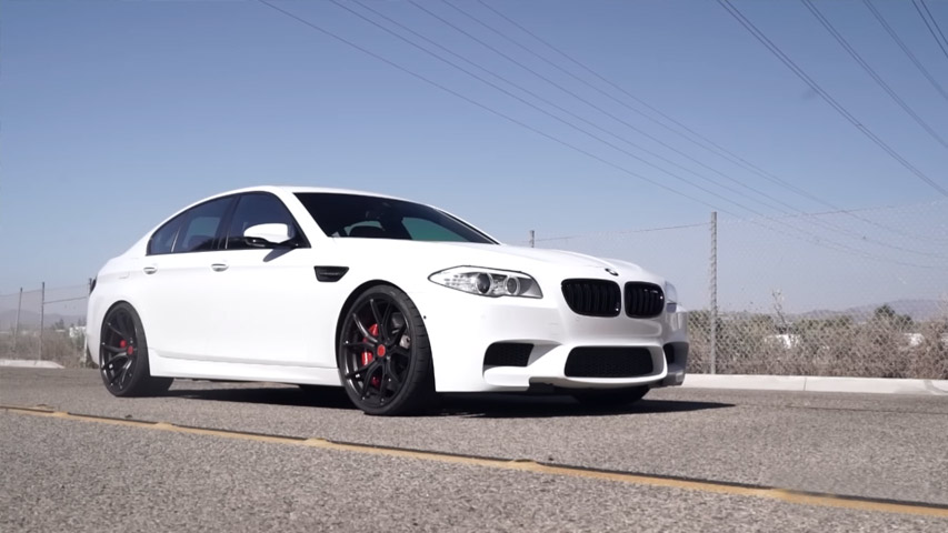 black rims on white car