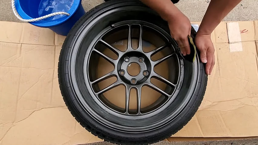 black rims on white car